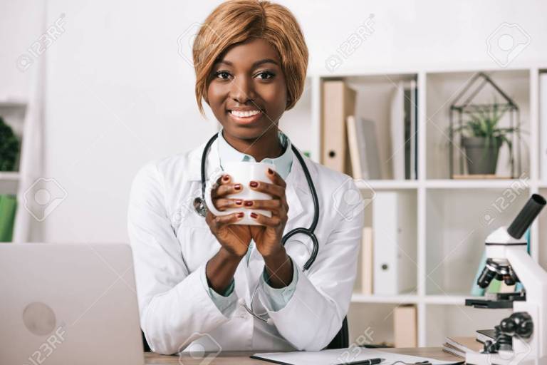 happy female african american scientist holding cup