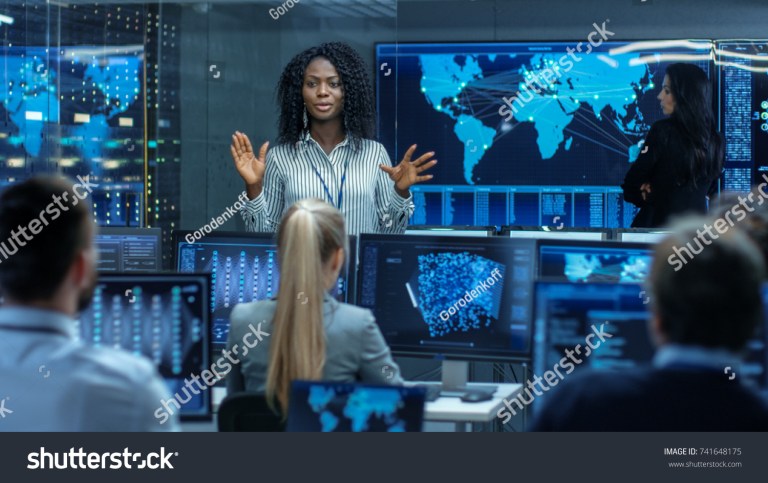 stock-photo-chief-project-engineer-holds-briefing-for-a-team-of-scientists-that-are-building-machine-learning-741648175